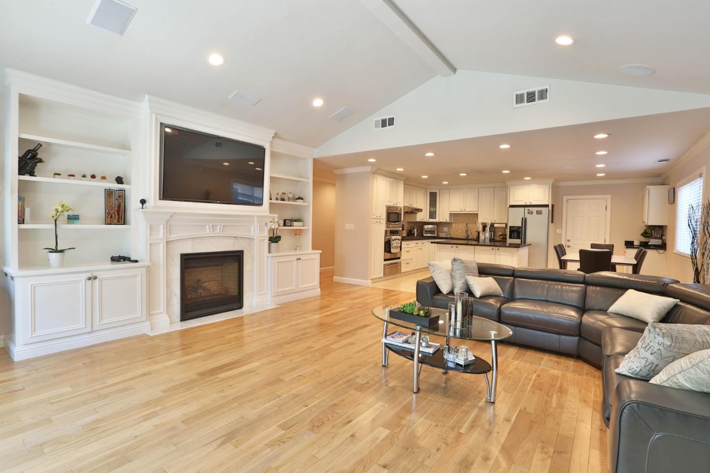 1053 Wallace Drive San Jose, CA 95120 - Photo 13 of 36 a living room with furniture a fireplace and a flat screen tv
