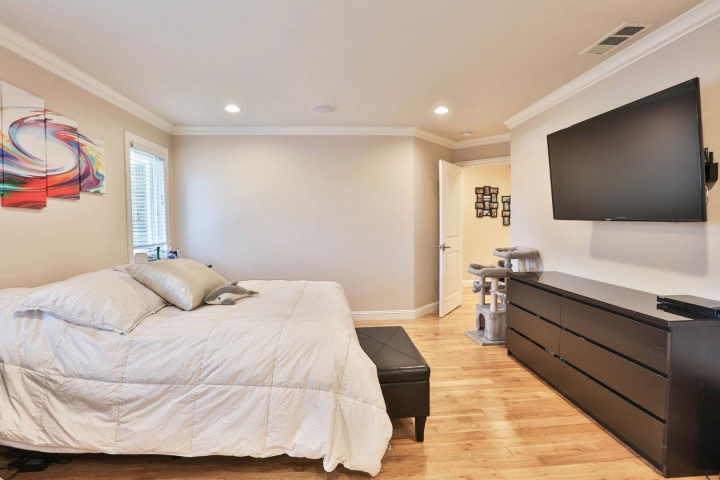1053 Wallace Drive San Jose, CA 95120 - Photo 18 of 36 a bedroom with a bed and a flat screen tv