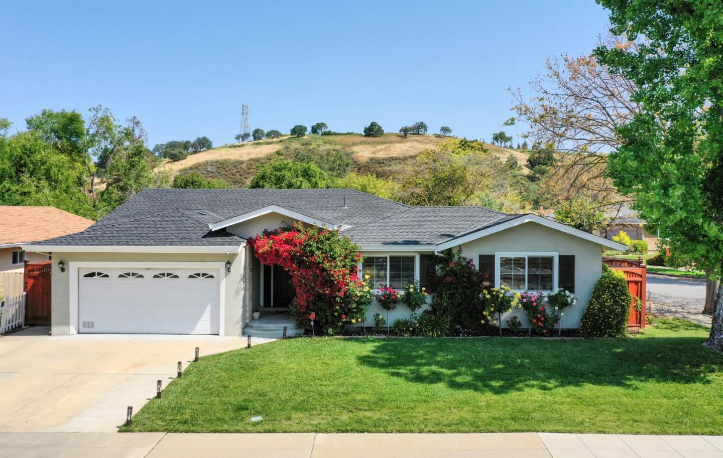 1053 Wallace Drive San Jose, CA 95120 - Photo 5 of 36 a front view of a house with a yard and trees