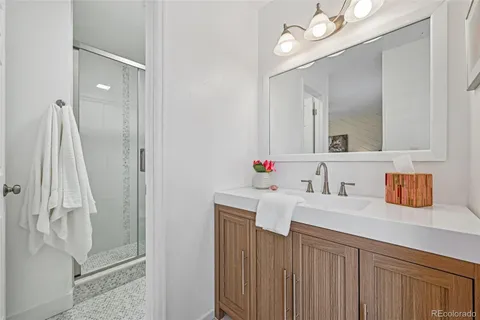a bathroom with a sink vanity tub and a mirror