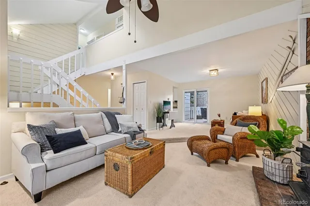 a living room with furniture potted plant and a chandelier