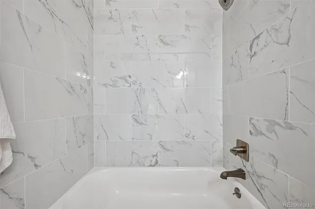 a bedroom with a bed and a chair