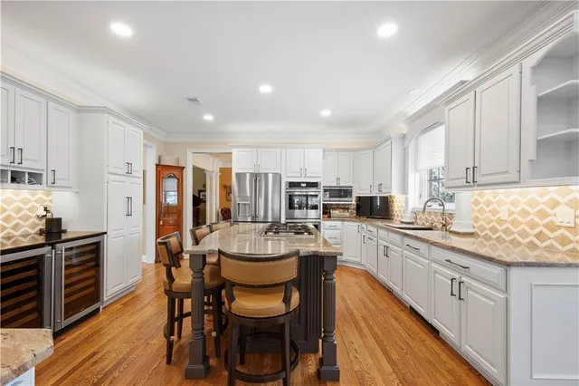 a kitchen with a dining table chairs and white appliances