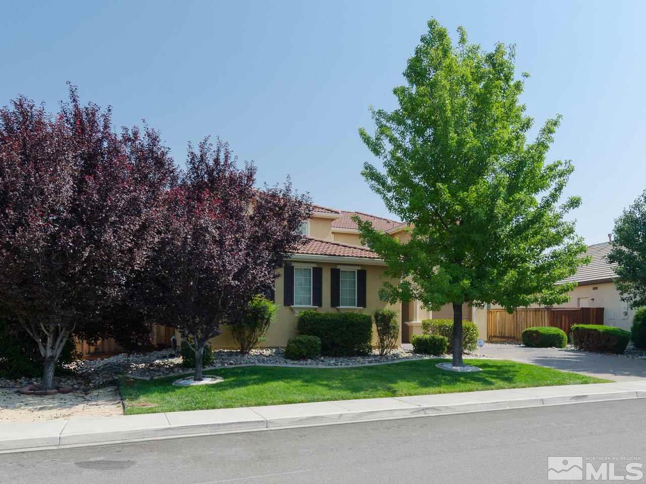 545 Luciana Drive Reno, NV 89521 - Photo 3 of 24 a front view of a house with a yard and a garage