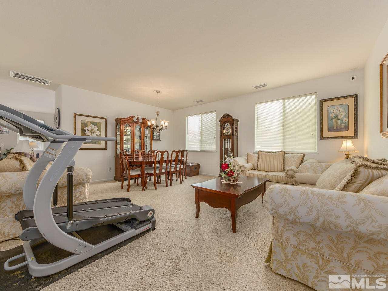545 Luciana Drive Reno, NV 89521 - Photo 6 of 24 a living room with furniture and a floor to ceiling window