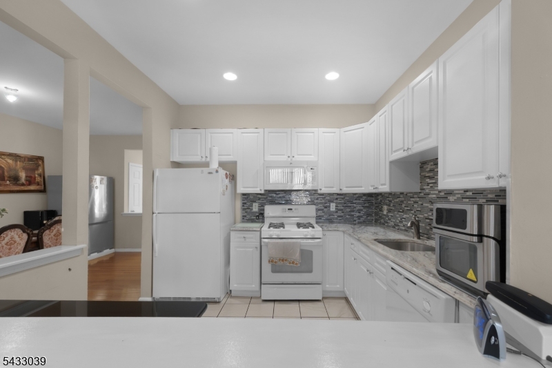 158 Autumn Ridge Road Morris Plains, NJ 07950 - Photo 3 of 26 a kitchen with a sink stainless steel appliances and cabinets