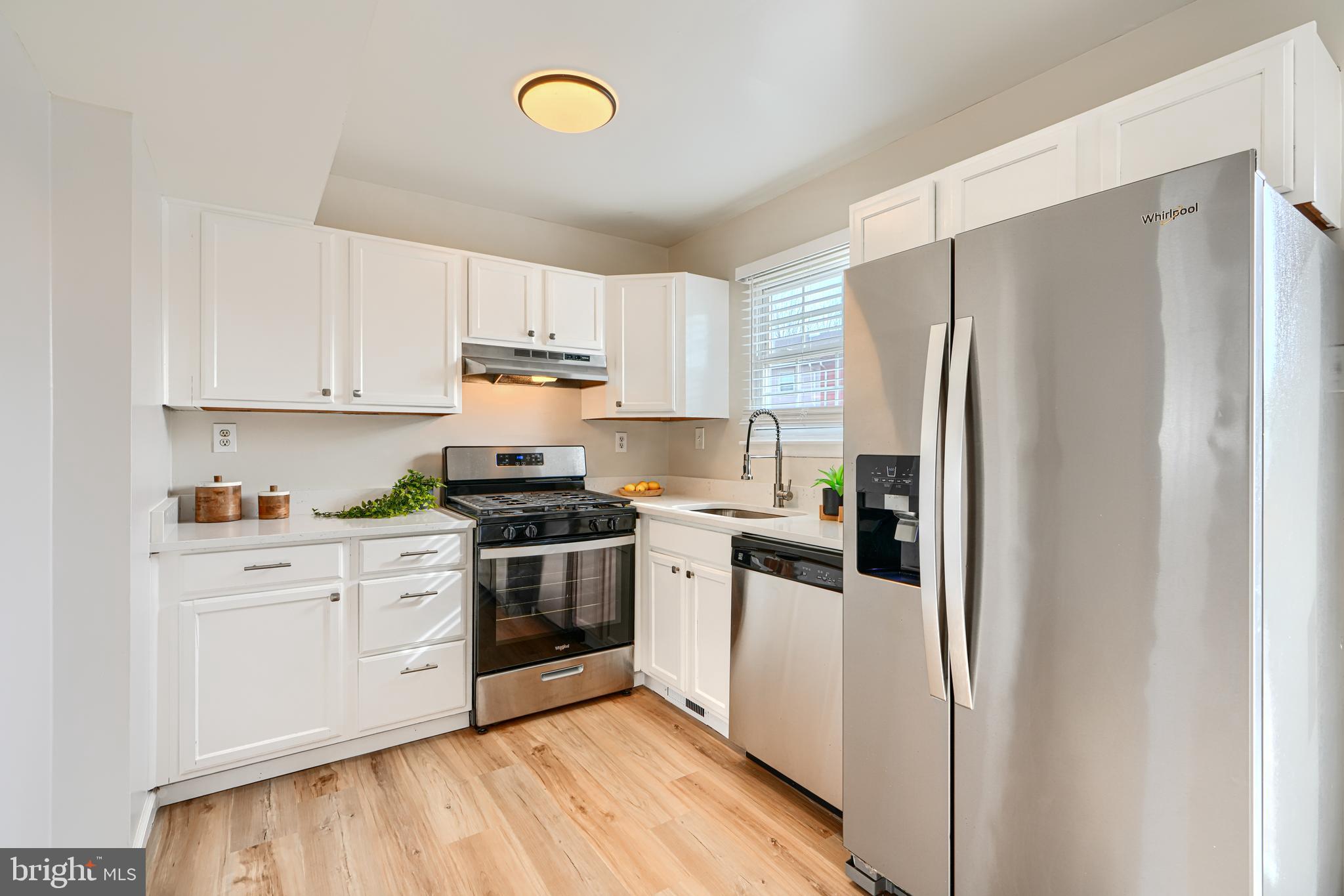8 King Richard Court, Unit 8 Rosedale, MD 21237 - Photo 11 of 41 a kitchen with stainless steel appliances a refrigerator sink and cabinets
