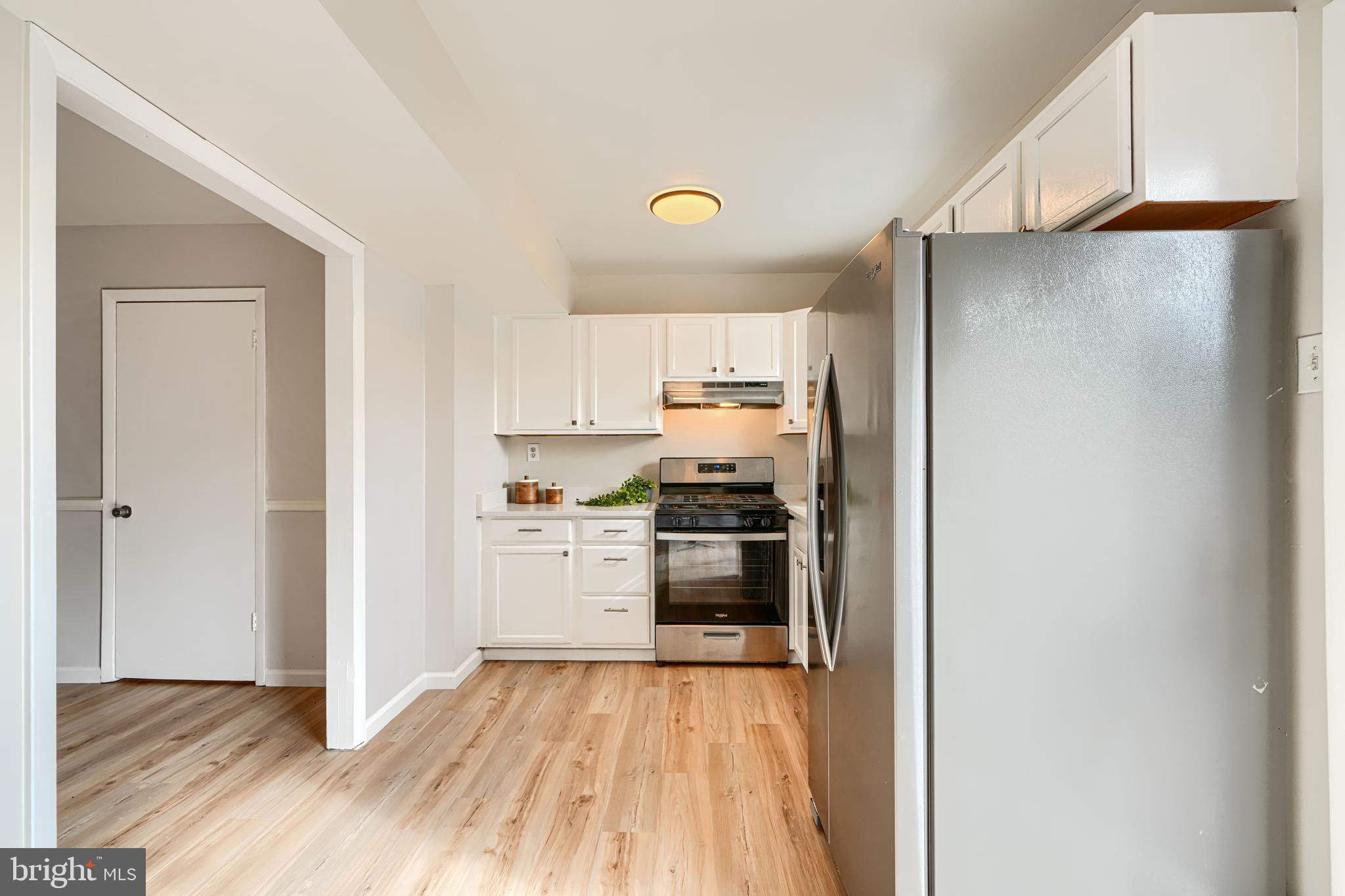 8 King Richard Court, Unit 8 Rosedale, MD 21237 - Photo 12 of 41 a kitchen with a refrigerator and a stove top oven