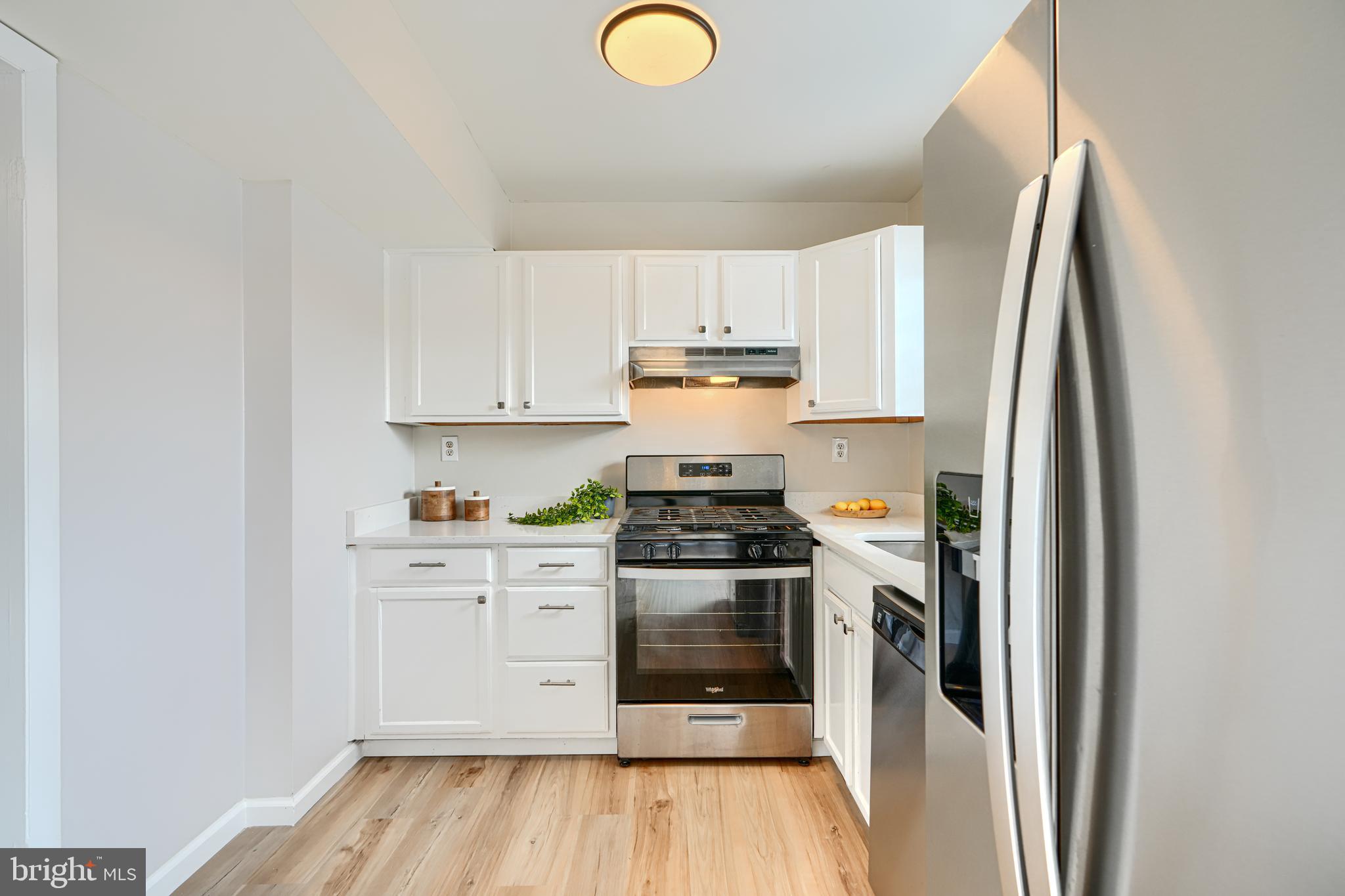 8 King Richard Court, Unit 8 Rosedale, MD 21237 - Photo 13 of 41 a kitchen with stainless steel appliances granite countertop a stove a refrigerator and a cabinets