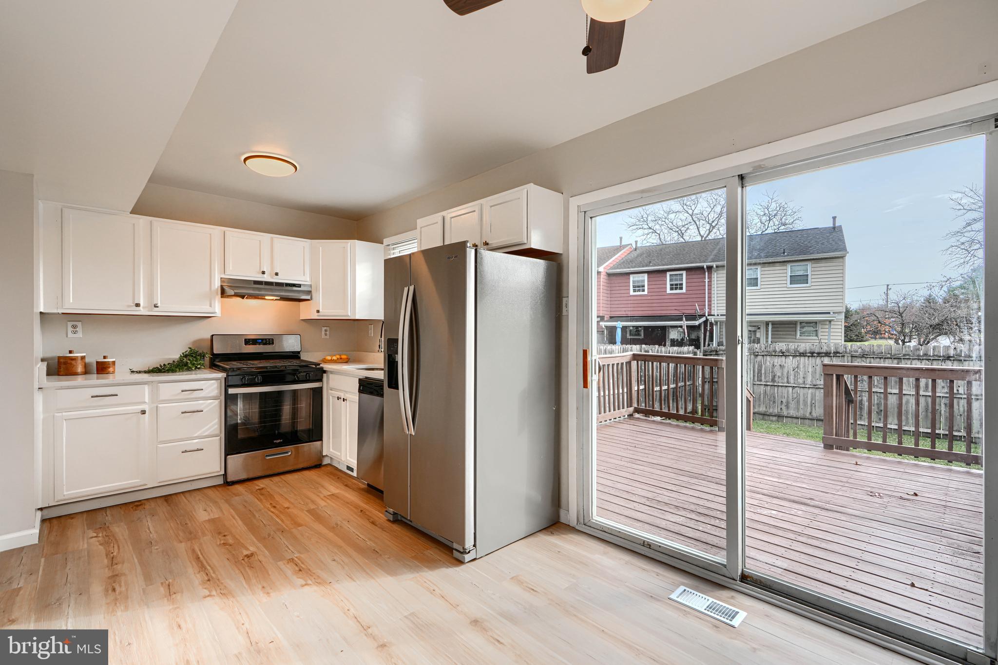 8 King Richard Court, Unit 8 Rosedale, MD 21237 - Photo 17 of 41 a kitchen with granite countertop a refrigerator and a stove top oven