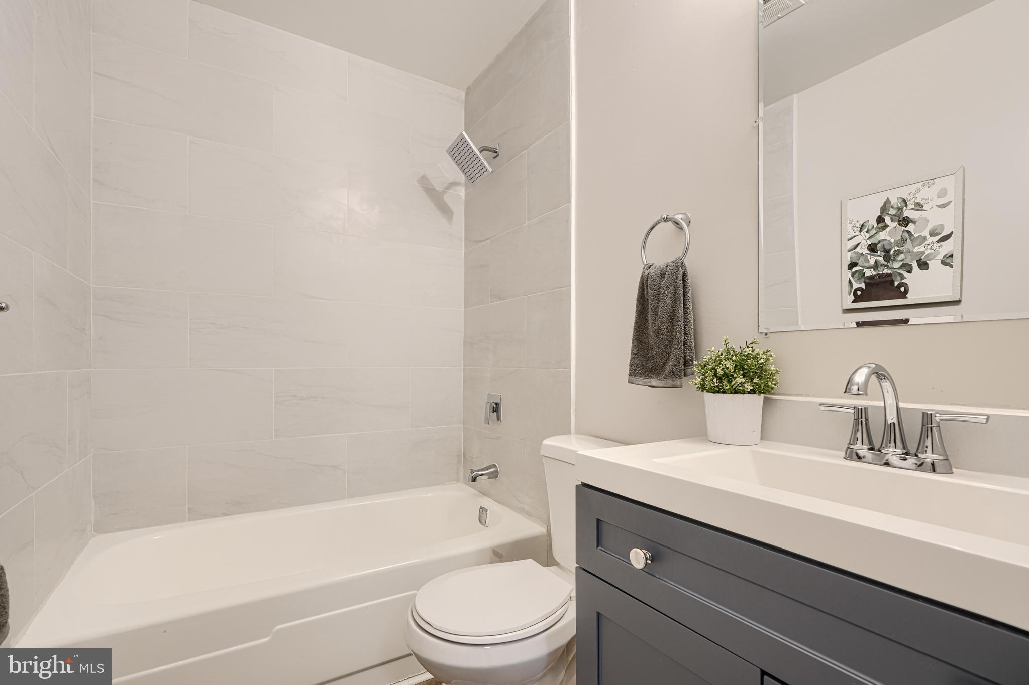 8 King Richard Court, Unit 8 Rosedale, MD 21237 - Photo 23 of 41 a bathroom with a sink a toilet and bathtub