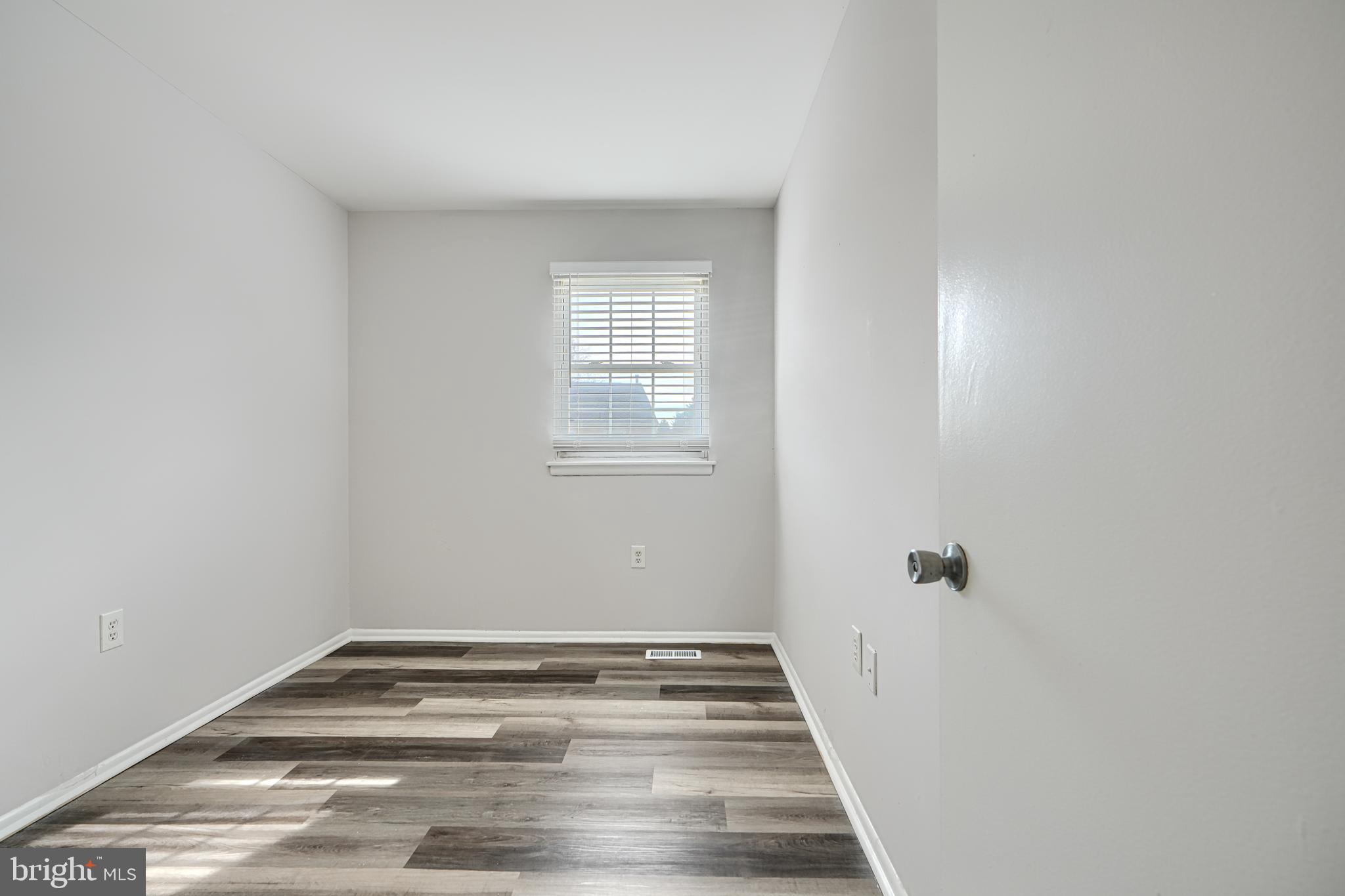 8 King Richard Court, Unit 8 Rosedale, MD 21237 - Photo 29 of 41 a view of an empty room with wooden floor and a window