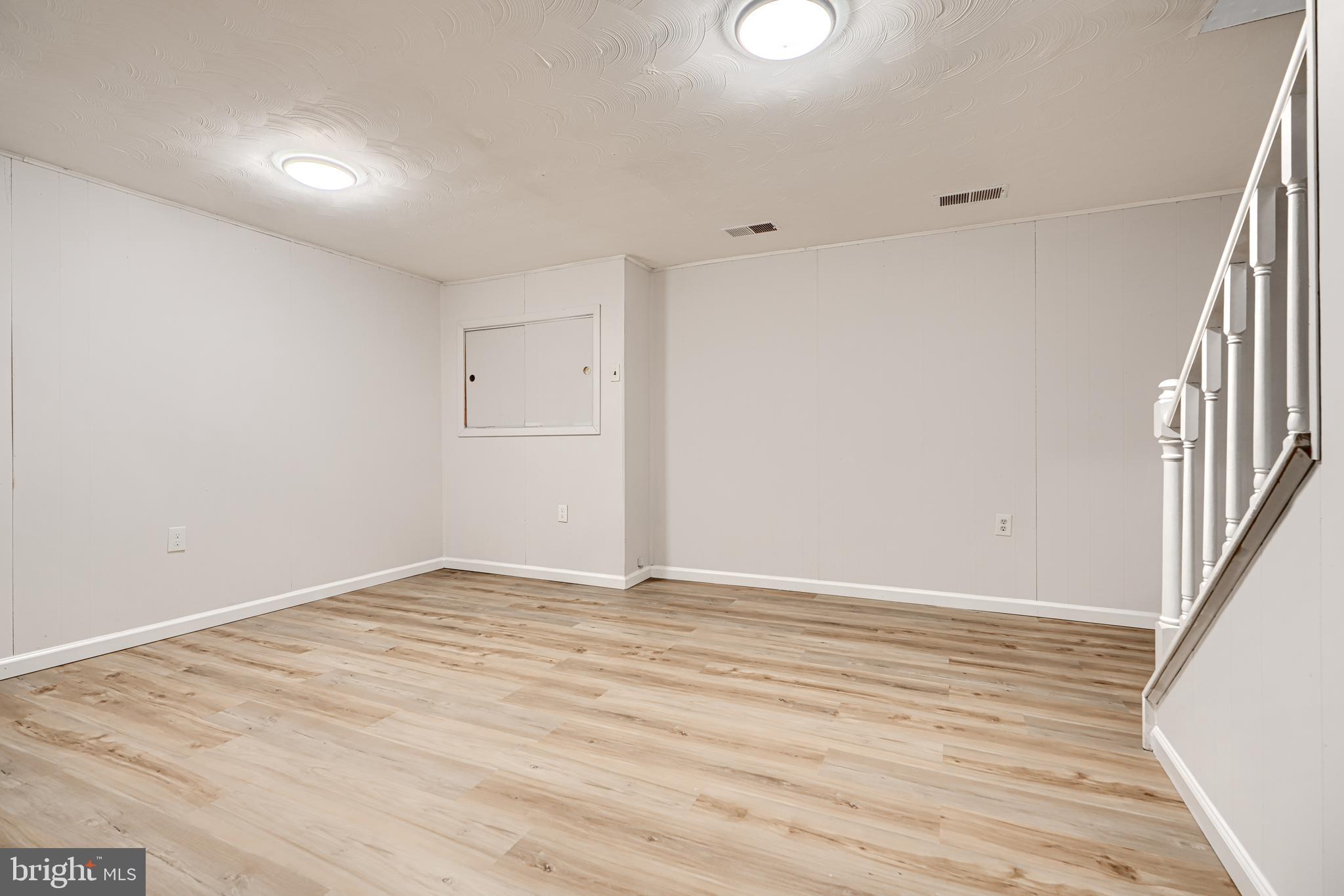 8 King Richard Court, Unit 8 Rosedale, MD 21237 - Photo 34 of 41 a view of an empty room with wooden floor