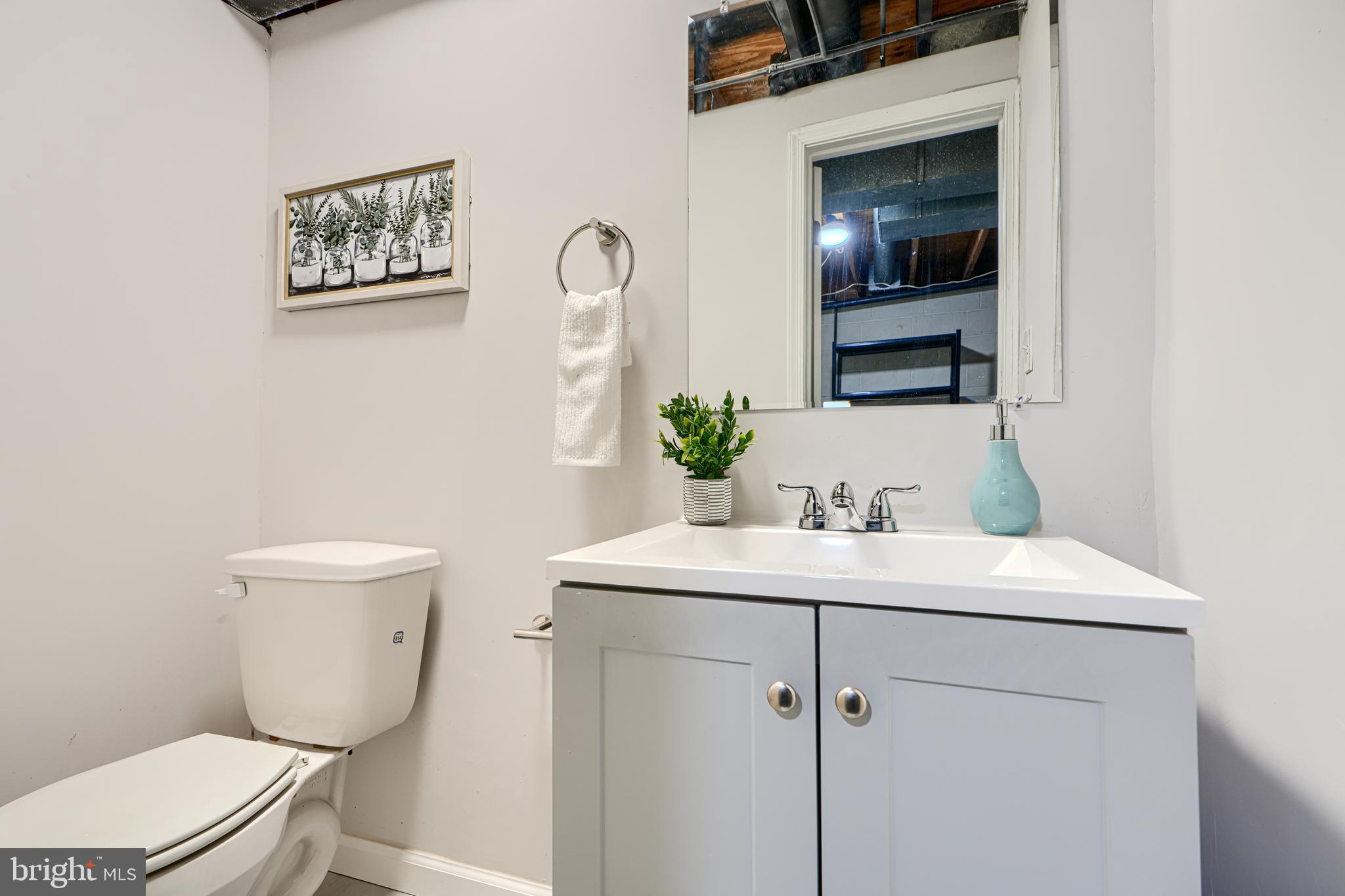 8 King Richard Court, Unit 8 Rosedale, MD 21237 - Photo 36 of 41 a bathroom with a toilet sink and mirror