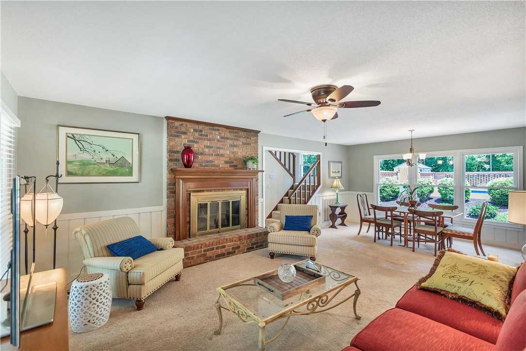 910 Chantilly Lane Anderson, SC 29625 - Photo 6 of 38 Warm and inviting, this living room features a classic brick fireplace and natural light from large windows.