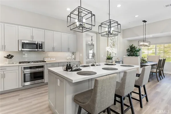 a kitchen with appliances a sink and cabinets