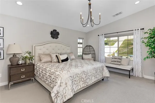 a bedroom with a large bed and a window