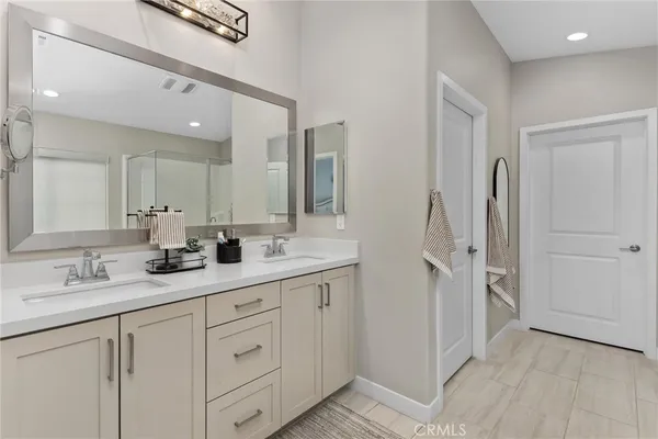 a bathroom with a double vanity sink double and mirror