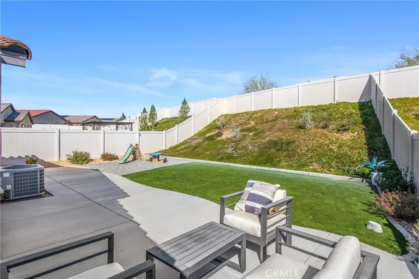 a backyard of a house with table and chairs