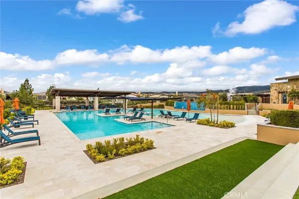 a view of a swimming pool with lounge chairs