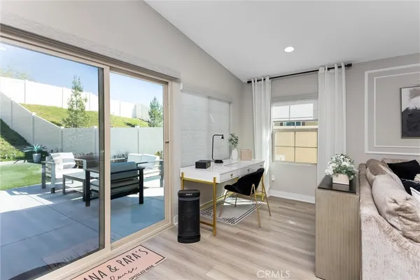 a living room with furniture a large window and chairs