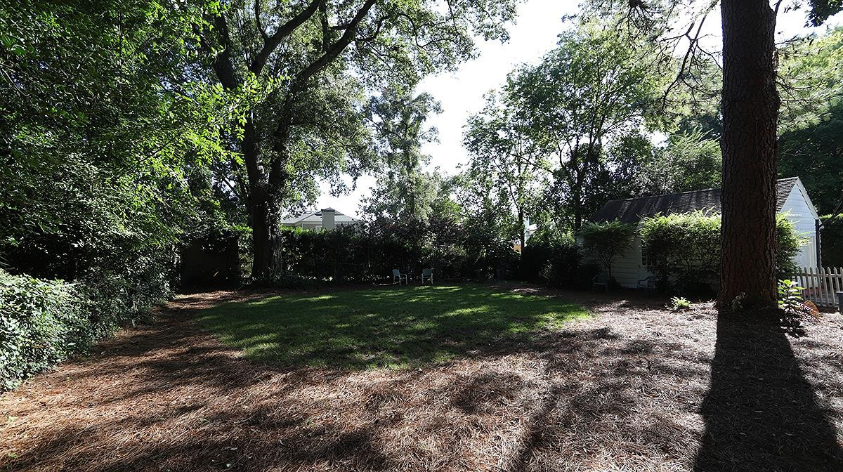 1608 Craig Street Raleigh, NC 27608 - Photo 37 of 42 Gorgeous lot with fenced in back yard and beautiful large oak trees as well as mature fig tree and camellias. Back Yard