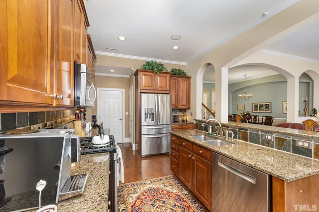 a large kitchen with a large counter top appliances and cabinets