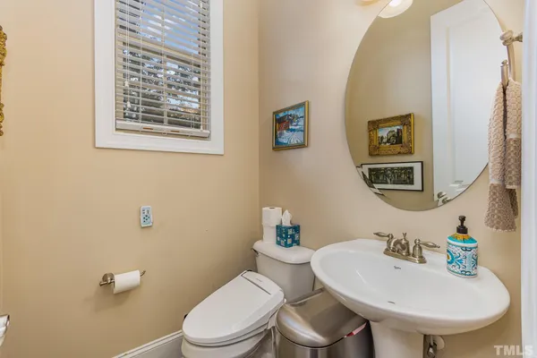 a bathroom with a toilet a sink and a mirror