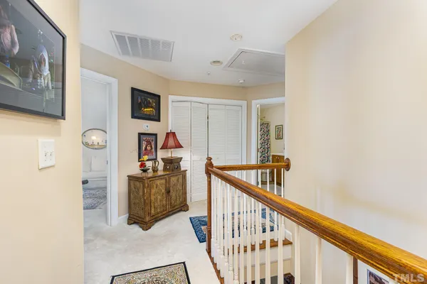 a view of a hallway with wooden floor and staircase