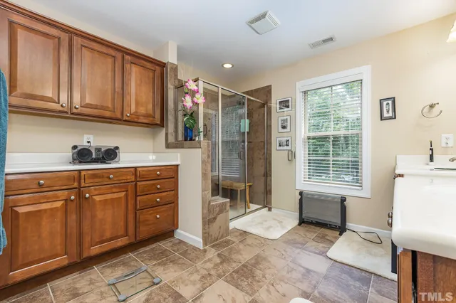 a kitchen with a refrigerator a stove a sink and cabinets