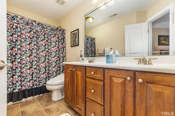 a bathroom with a sink toilet and a mirror