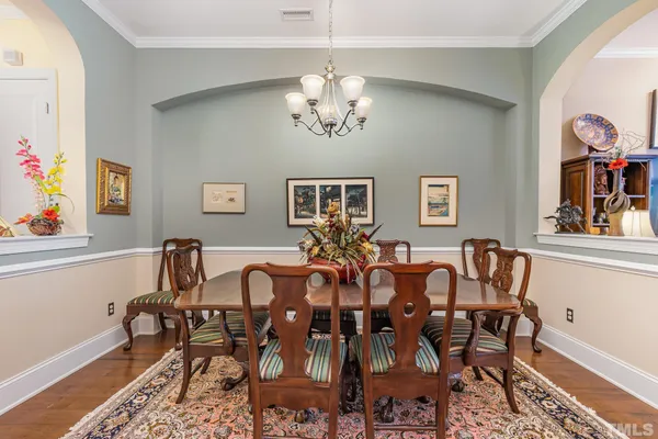 a view of a dining room with furniture and chandelier