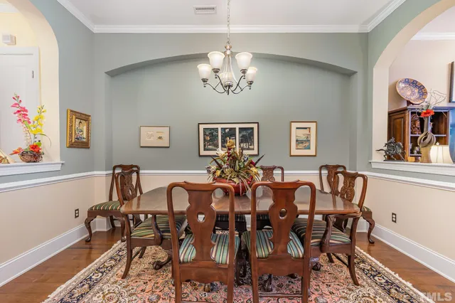 a view of a dining room with furniture and chandelier