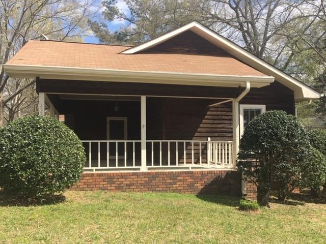 a view of house with backyard