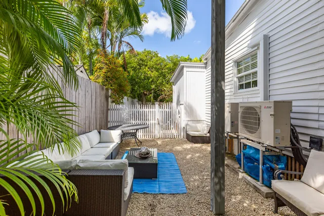 a view of a patio with couches chairs and a potted plant