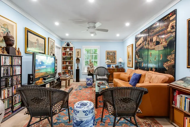 a living room with lots of furniture and a large window