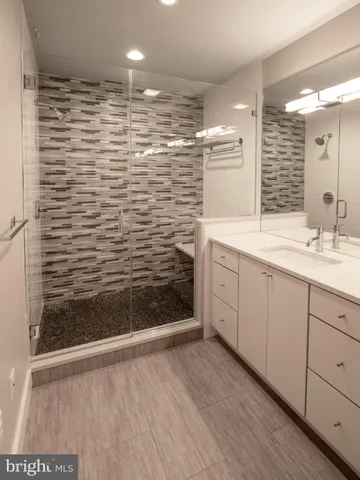 a bathroom with a shower and a sink