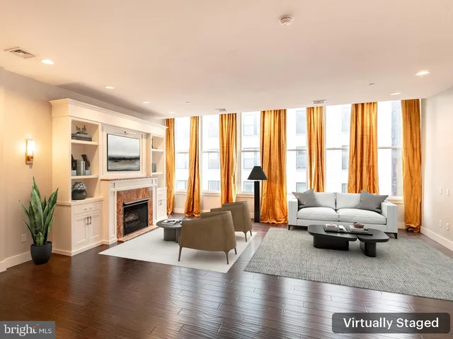 a living room with furniture window and a fireplace