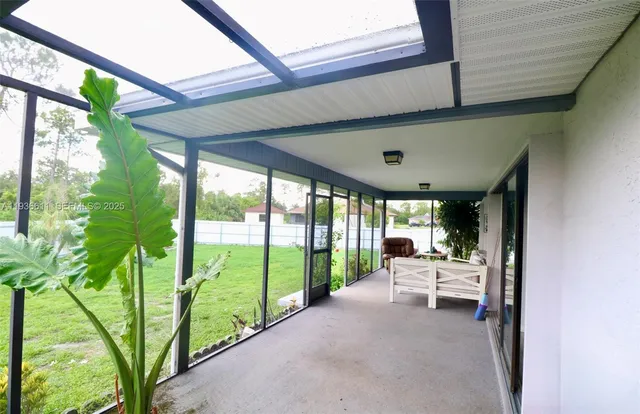 a living room with large windows and furniture