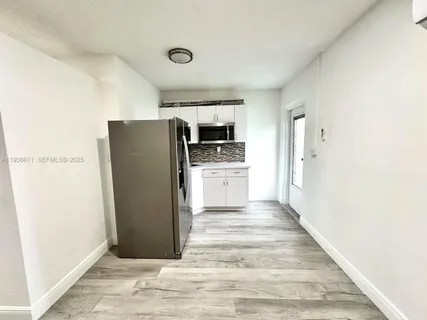 a kitchen with a refrigerator and a stove