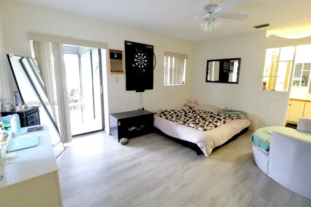 a bedroom with a bed window and a couch