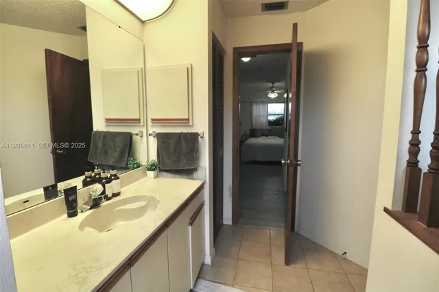a en suite bathroom with a sink and a mirror