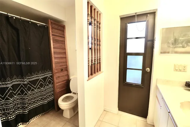 a bathroom with a toilet a sink and shower