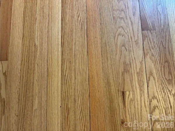 a kitchen with stainless steel appliances granite countertop a refrigerator a stove a sink a oven with a dining table and chairs