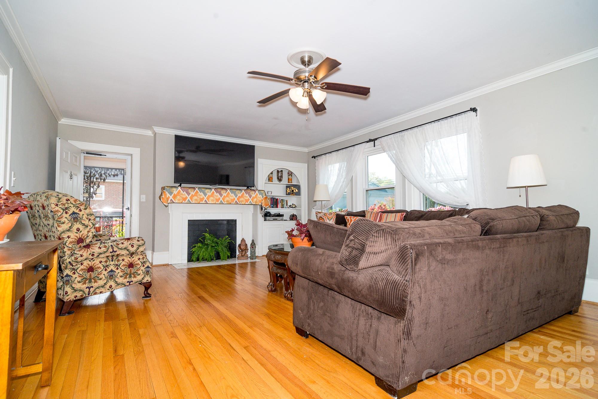 610 East Main Street Cherryville, NC 28021 - Photo 16 of 48 a living room with furniture a fireplace and a flat screen tv