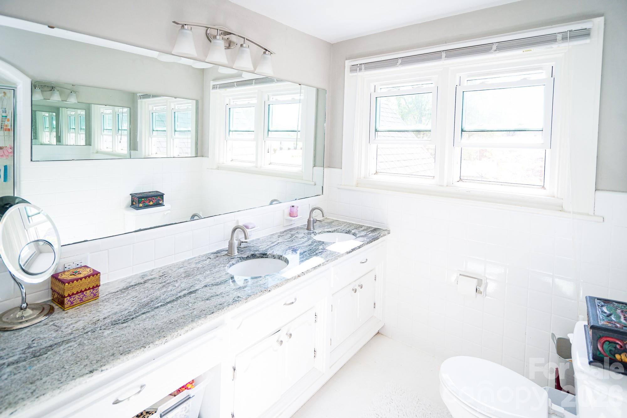 610 East Main Street Cherryville, NC 28021 - Photo 43 of 48 a bathroom with a granite countertop sink mirror vanity and toilet