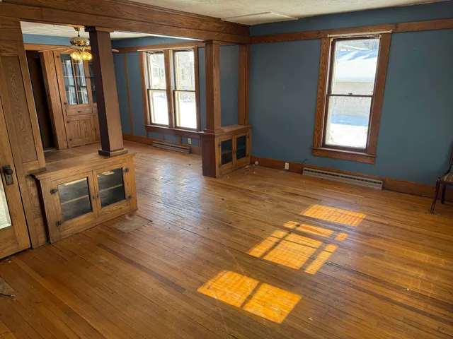wooden floor in an empty room with a window
