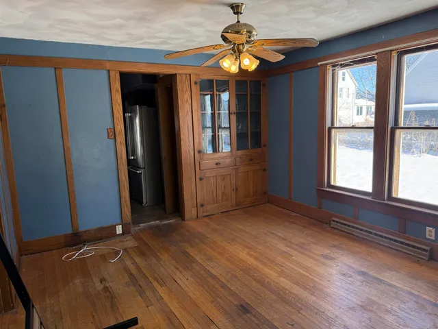 wooden floor in an empty room with a window