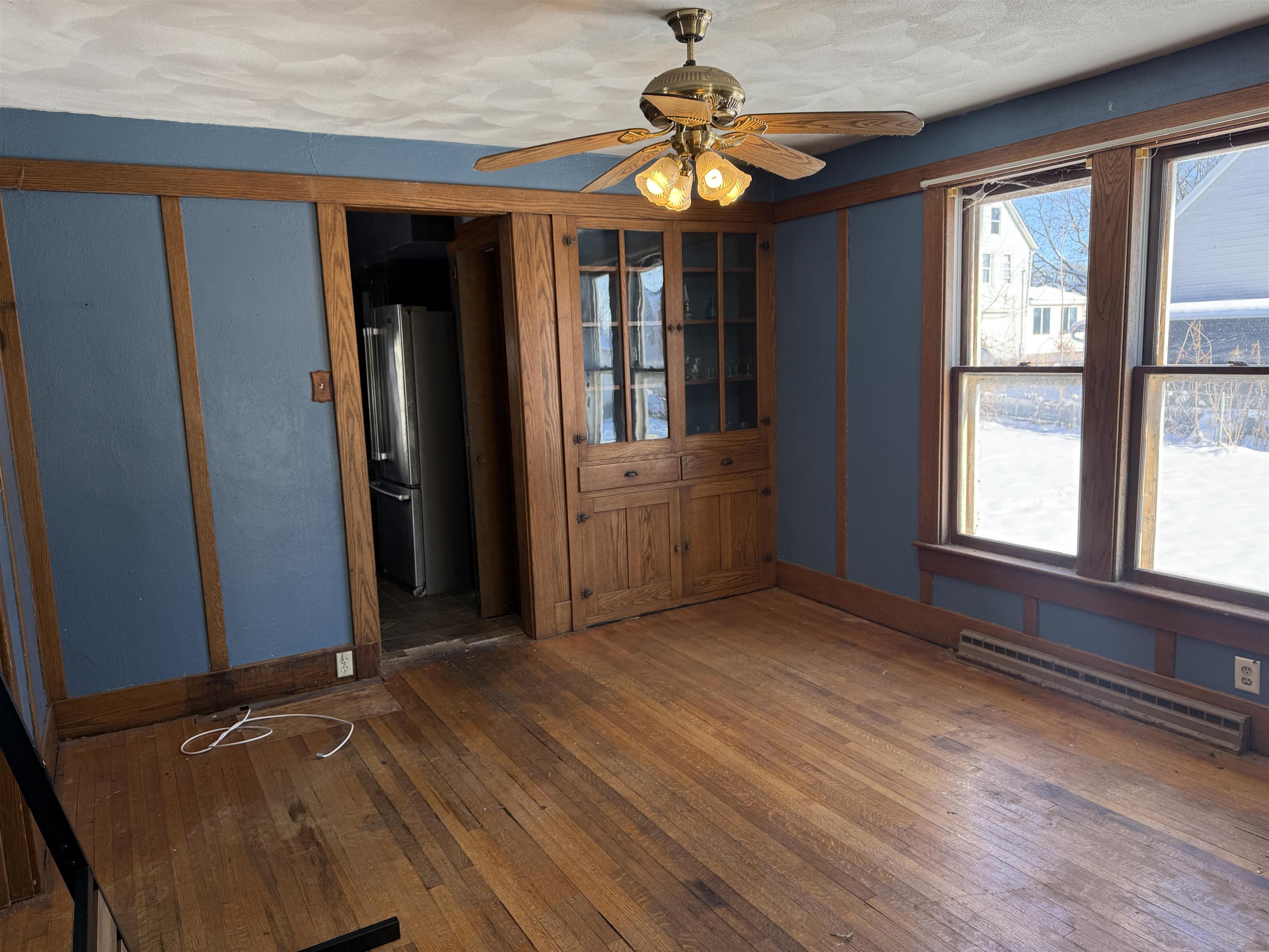 816 West Pleasant Street Freeport, IL 61032 - Photo 3 of 13 wooden floor in an empty room with a window