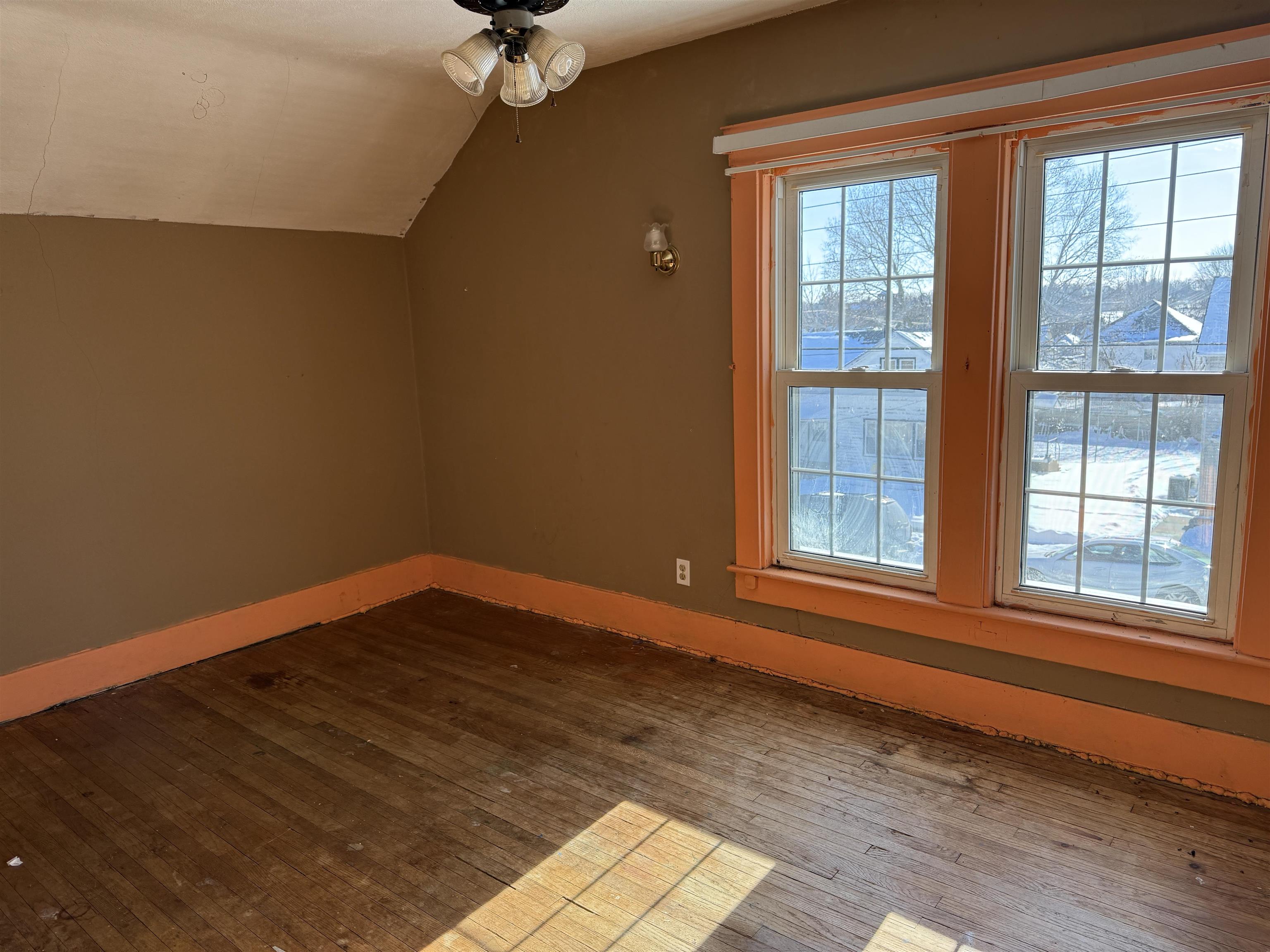 816 West Pleasant Street Freeport, IL 61032 - Photo 6 of 13 a view of an empty room with wooden floor and a window